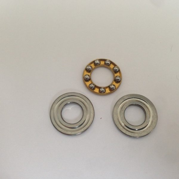Washer and axial bearing for piston heads or spring guide